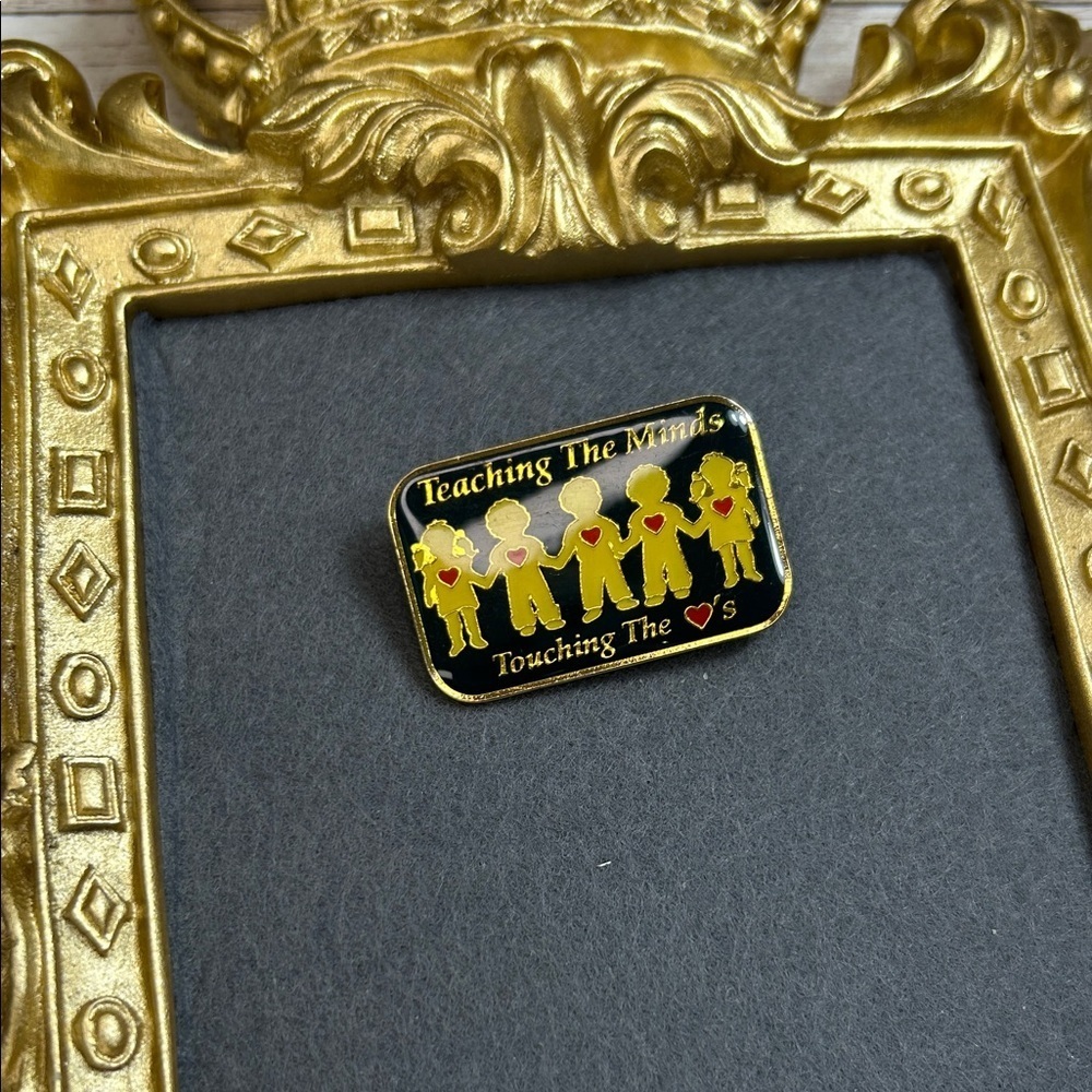 Teaching The Minds Touching The Hearts Pin